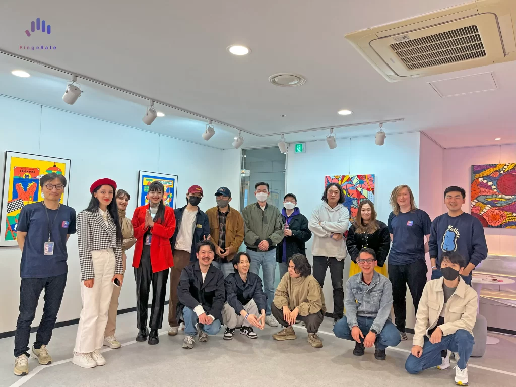 A group of people, including the Korean artists HAchi and Mothfly, taking a picture during the first exhibition FingeRate X.