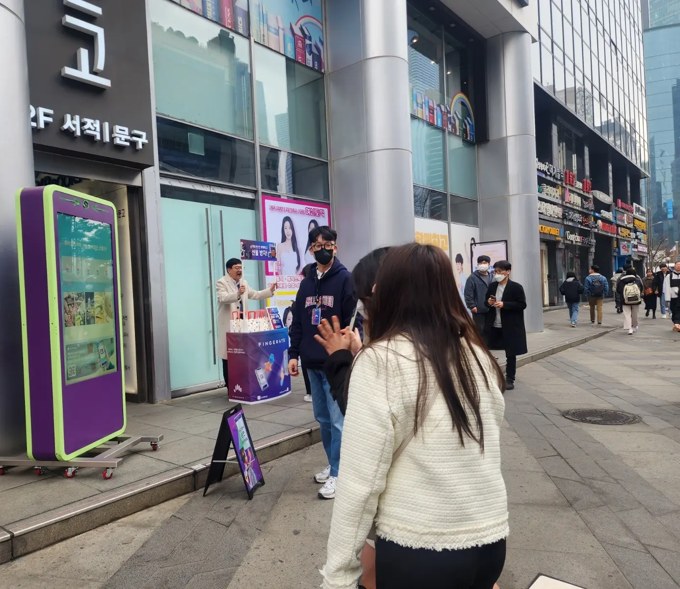 Group of people standing in front of YBM building, located in Gangnam (South Korea)