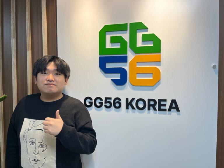 Photo of a Korean developer standing next to GG56 Korea logo